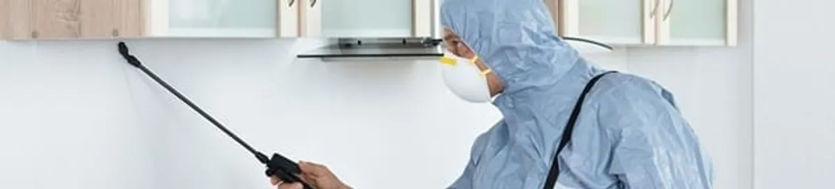 Termite treatment technician applying indoor pest control spray in Sacramento, CA
